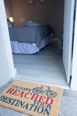 a door leading to a bedroom with a welcome mat at The Vintage Crane Guest House in Caledon