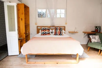 a bedroom with a bed and a window at 4 ON REGENT in Greyton