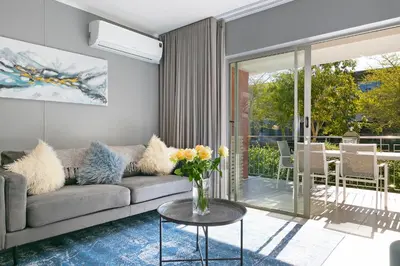 a living room with a couch and a table at Century City Luxury Two Bedroom Apartment in Cape Town