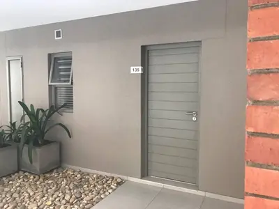 a garage door on the side of a house at Century City Luxury Two Bedroom Apartment in Cape Town