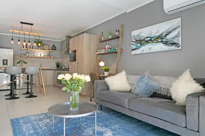 a living room with a couch and a table at Century City Luxury Two Bedroom Apartment in Cape Town