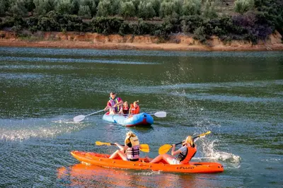 a group of people in kayaks on a river at Vredehoek Guest Farm in Breerivier