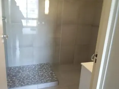 a bathroom with a shower with a glass door at Sunset 786 Holiday Accom-212 in Strand