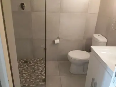 a bathroom with a shower with a toilet and a sink at Sunset 786 Holiday Accom-212 in Strand