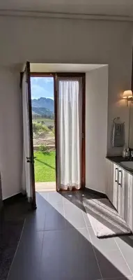 a room with an open door with a view at Farm Stay Winelands in Paarl