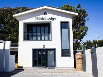 a white building with a sign that reads noble lodge at The Noble Lodge in Cape Town