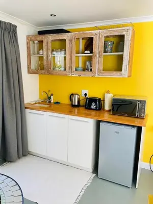 a kitchen with a counter top and a microwave at Modern studio apartment in Cape Town