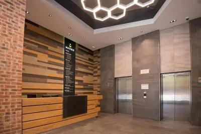 a lobby with a directional sign on the wall at Six One Five at Matrix in Cape Town