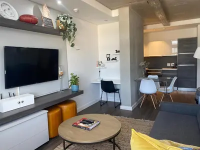 a living room with a flat screen tv on a wall at Six One Five at Matrix in Cape Town