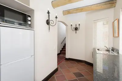 a kitchen with white cabinets and a tile floor at 4 Piet Retief in Stellenbosch