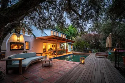 a backyard with a pool and a house at Heron House at Bartholomeus Klip in Hermon