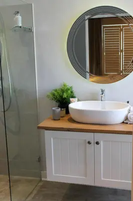 a bathroom with a sink and a mirror at LA RÉVERIE in Franschhoek