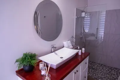 a bathroom with a white sink and a mirror at LA RÉVERIE in Franschhoek