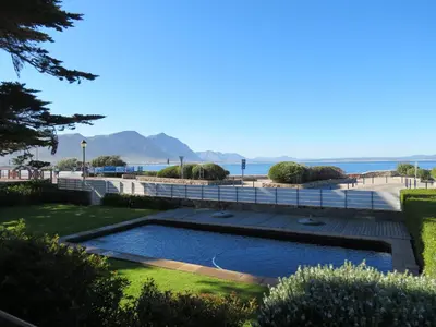 a swimming pool with the ocean in the background at 74 on Marine in Hermanus