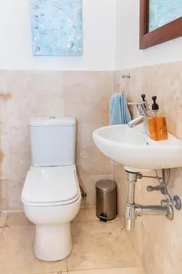 a bathroom with a toilet and a sink at 74 on Marine in Hermanus