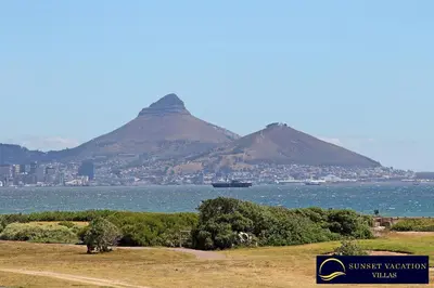 a view of the mountains with a city and the water at Kite Surfers Beach Villa in Cape Town