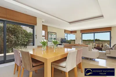 a dining room with a table and chairs at Kite Surfers Beach Villa in Cape Town