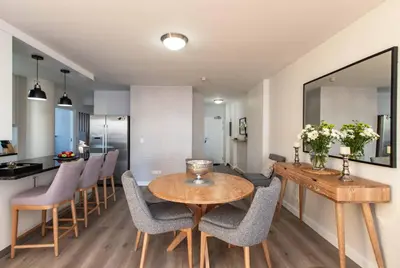 a kitchen and dining room with a table and chairs at Hibernian Towers 807, Beach Road, Strand in Strand