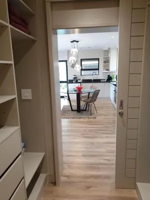 a kitchen and dining room with a dining table at Vrede Selfcatering in Somerset West