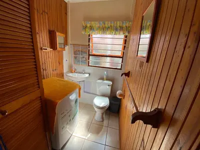 a small bathroom with a toilet and a sink at Hermanus 60 on Flat in Hermanus