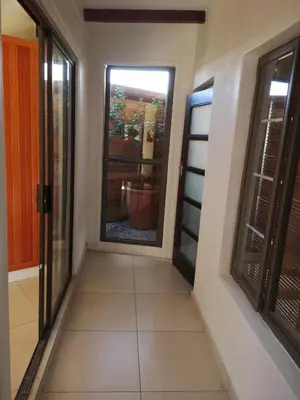 a hallway with a door and a window at Bona Lodge in Cape Town