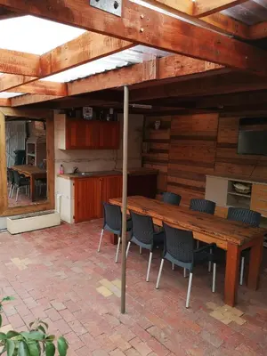 a large wooden table and chairs in a kitchen at Bona Lodge in Cape Town