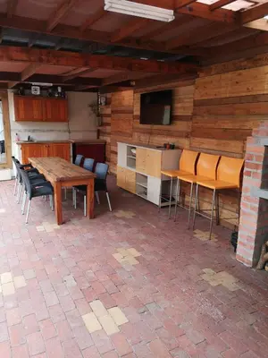 a patio with a table and chairs and a kitchen at Bona Lodge in Cape Town