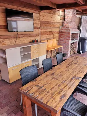 a large wooden table and chairs in a room at Bona Lodge in Cape Town