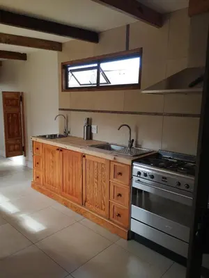 a kitchen with a sink and a stove at Bona Lodge in Cape Town