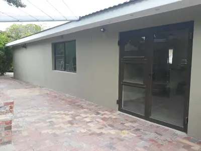 a building with a door on the side of it at Little Elm Cottage in Cape Town