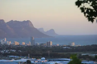 a view of a city with mountains and the water at Somerset-West, Heldervue in Cape Town