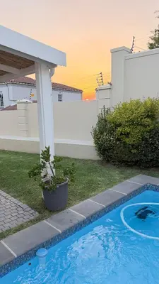 a swimming pool in the yard of a house at Onrus Holiday Home on Private Estate with Pool in Hermanus