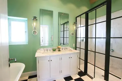 a bathroom with two sinks and a shower at La Cotte The Manor House in Franschhoek