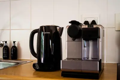 a coffeemaker and a coffee maker on a kitchen counter at Hilton House in Pringle Bay