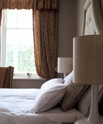 a bedroom with a bed with pillows and a window at Banksia Boutique Hotel & Spa in Cape Town