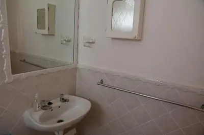 a bathroom with a sink and a mirror at Bradclin Sport Newlands in Cape Town