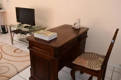 a desk with a tv and a teddy bear on it at Bradclin Sport Newlands in Cape Town