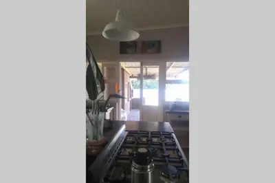 a kitchen with a stove top oven in a kitchen at Angel's Place by the Sea in Hermanus