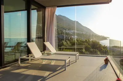 a balcony with a table and two chairs and a view at Redrock Ocean View Villa in Cape Town