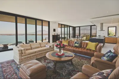 a large living room with couches and a table at Redrock Ocean View Villa in Cape Town