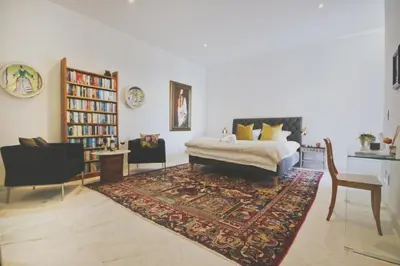 a living room with a bed and a rug at Redrock Ocean View Villa in Cape Town