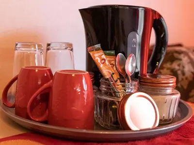 a tray with cups and utensils on a table at Lyronne Guest house, Shuttle and Tours in Cape Town