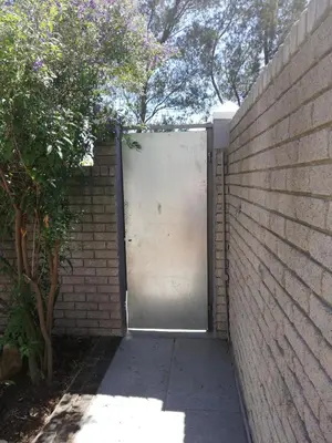a metal garage door in a brick wall at sunny get away for a family of 4 in Cape Town