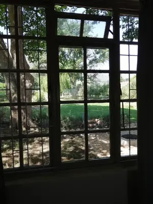 a window view of a yard from a house at Cabernet Cottage Be Still and Know in Franschhoek