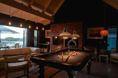 a living room with a pool table in a room at Villa Le Roc Kleinmond Accommodation in Kleinmond