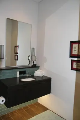 a bathroom with a sink and a large mirror at The Vineyard Cottage by L' Amitie Estate in Franschhoek