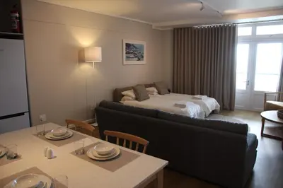 a hotel room with a bed and a dining table at The Boardwalk Accommodation in Gordonʼs Bay