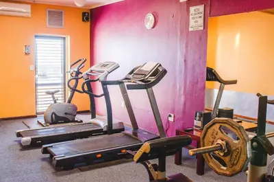 a gym with three exercise bikes in a room at Strand Pavilion in Strand