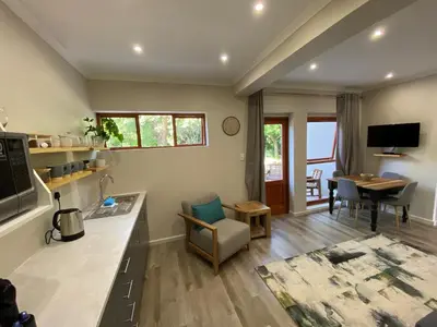 a living room with a kitchen and a dining room at Viettz Suite Annex in Stellenbosch