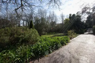 a brick path with plants and trees on the side at Viettz Suite Annex in Stellenbosch